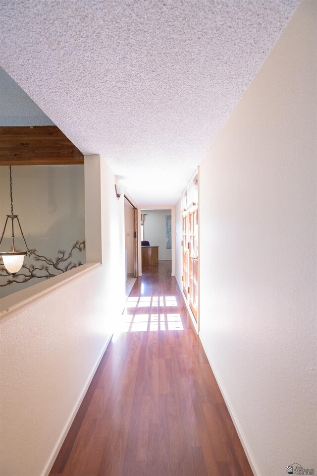 800 E Country Club Dr Unit 26, Yuma, AZ 85365 - hall with wood finished floors, baseboards, and a textured ceiling