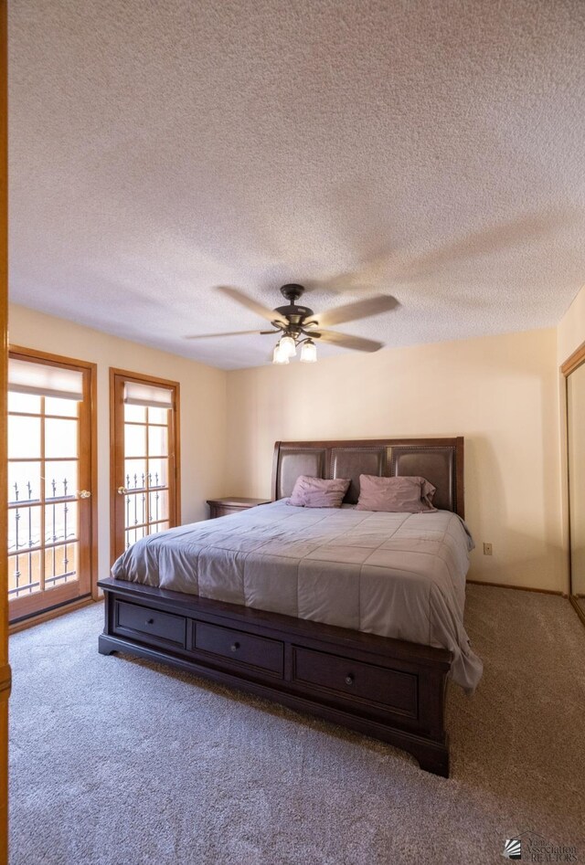 800 E Country Club Dr Unit 26, Yuma, AZ 85365 - bedroom featuring carpet, a textured ceiling, a ceiling fan, and access to exterior