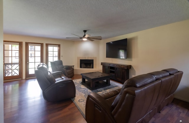 800 E Country Club Dr Unit 26, Yuma, AZ 85365 - living room with a fireplace, a textured ceiling, ceiling fan, and dark wood-type flooring