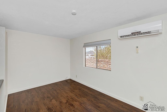 13466 E 47th St, Yuma, AZ 85367 - spare room with a wall mounted air conditioner and dark wood-style floors