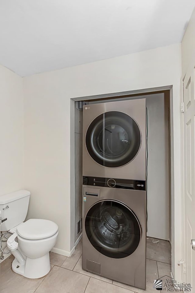 13466 E 47th St, Yuma, AZ 85367 - laundry area featuring stacked washer / dryer and light tile patterned floors