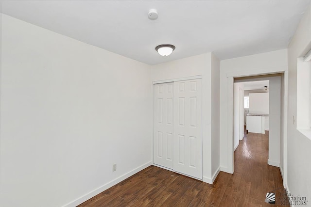 13466 E 47th St, Yuma, AZ 85367 - unfurnished bedroom with dark wood-style flooring and a closet