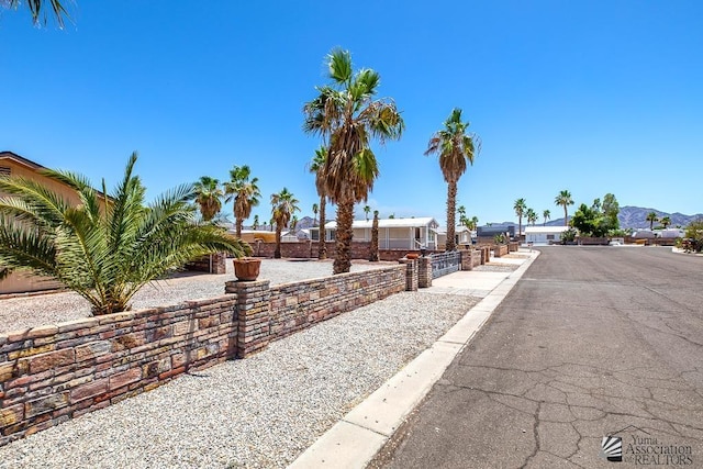 13466 E 47th St, Yuma, AZ 85367 - view of asphalt road with a residential view
