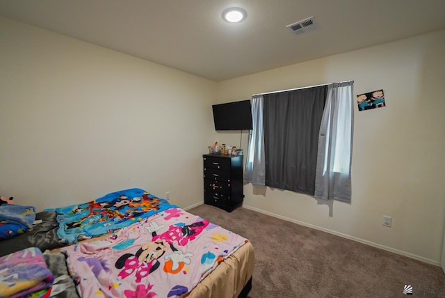 carpeted bedroom with baseboards and visible vents