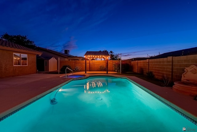 11594 E 27th Pl, Yuma, AZ 85367 - pool at dusk featuring a gazebo, a fenced backyard, a patio, and a pool with connected hot tub