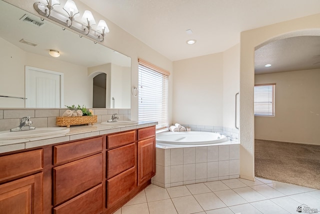 11594 E 27th Pl, Yuma, AZ 85367 - bathroom featuring a garden tub, double vanity, tile patterned flooring, and recessed lighting