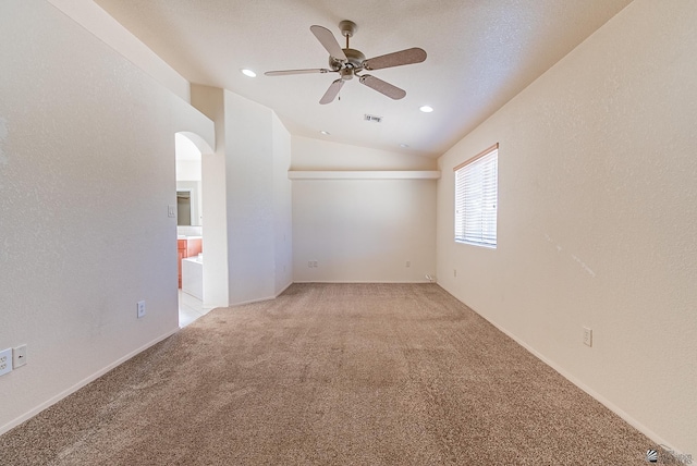 11594 E 27th Pl, Yuma, AZ 85367 - spare room featuring lofted ceiling, light carpet, a ceiling fan, arched walkways, and recessed lighting