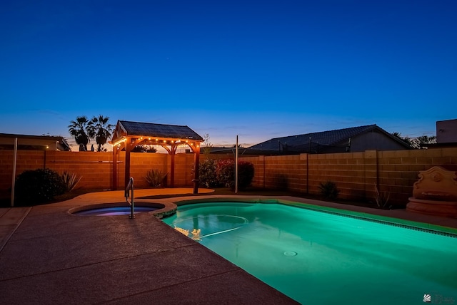11594 E 27th Pl, Yuma, AZ 85367 - pool at dusk with a gazebo, an in-ground hot tub, and a fenced backyard