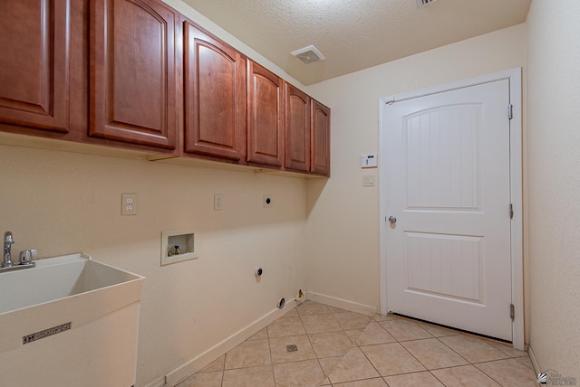 11594 E 27th Pl, Yuma, AZ 85367 - laundry area featuring hookup for an electric dryer, cabinet space, hookup for a washing machine, light tile patterned floors, and a textured ceiling