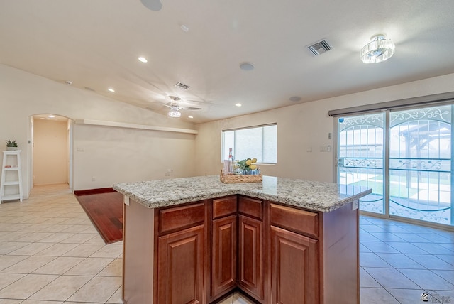 11594 E 27th Pl, Yuma, AZ 85367 - kitchen featuring light tile patterned floors, arched walkways, a ceiling fan, recessed lighting, and light stone countertops