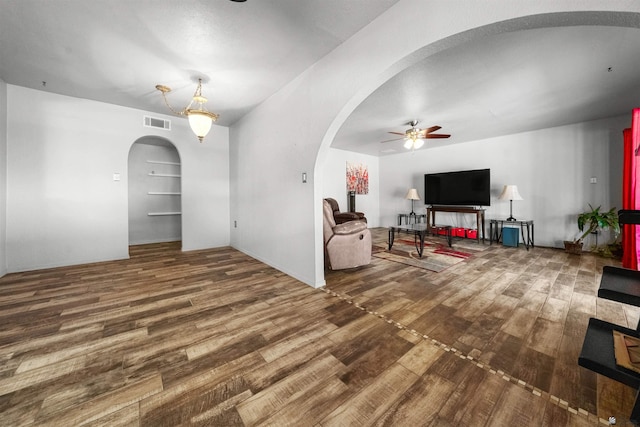 2621 S Walnut Ave, Yuma, AZ 85364 - living room with arched walkways, a ceiling fan, and wood finished floors