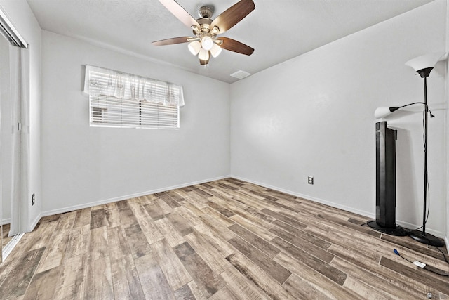 2621 S Walnut Ave, Yuma, AZ 85364 - unfurnished bedroom featuring wood finished floors, ceiling fan, and a closet