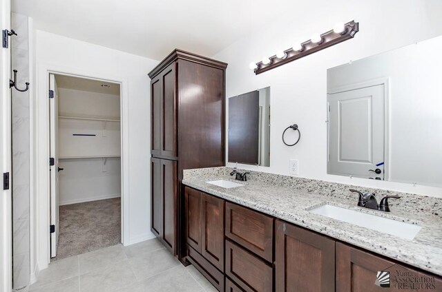 12683 E 51st Pl, Yuma, AZ 85367 - bathroom with double vanity, a spacious closet, and tile patterned floors