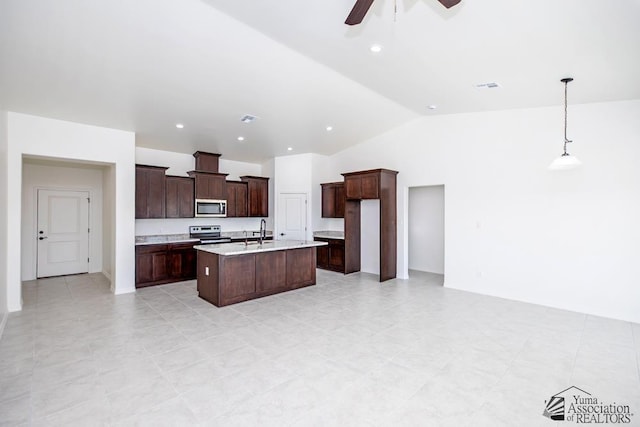 12683 E 51st Pl, Yuma, AZ 85367 - kitchen featuring appliances with stainless steel finishes, vaulted ceiling, a ceiling fan, light countertops, and a center island with sink