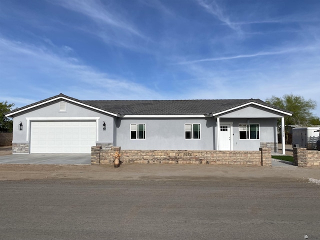 12408 S Paula Ave, Yuma, AZ 85367 - ranch-style house with stucco siding, a garage, driveway, and stone siding