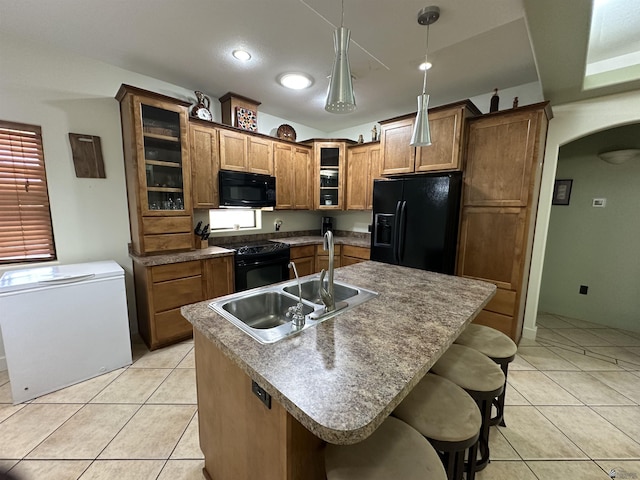 14411 E 50th Dr, Yuma, AZ 85367 - kitchen featuring black appliances, arched walkways, light tile patterned floors, glass insert cabinets, and recessed lighting