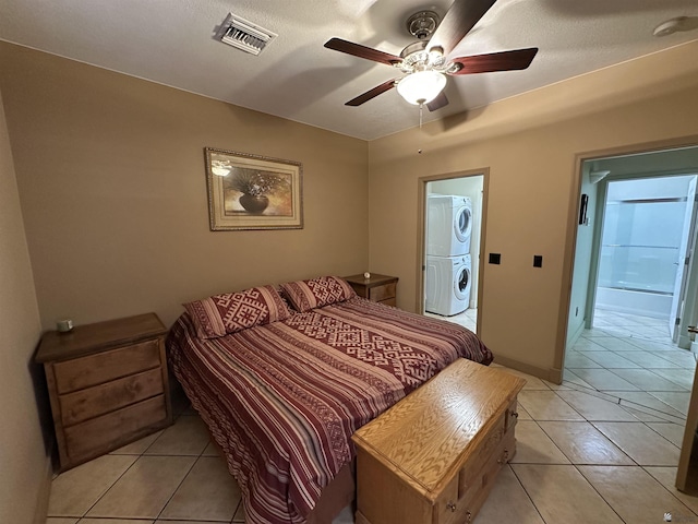 14411 E 50th Dr, Yuma, AZ 85367 - bedroom featuring stacked washer and clothes dryer, light tile patterned flooring, and ceiling fan