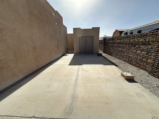 14411 E 50th Dr, Yuma, AZ 85367 - view of home's exterior with stucco siding, a patio, and a shed