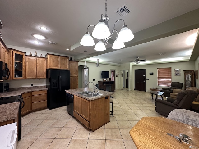 14411 E 50th Dr, Yuma, AZ 85367 - kitchen featuring black appliances, open floor plan, brown cabinets, light tile patterned floors, and a chandelier