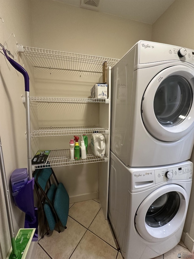 14411 E 50th Dr, Yuma, AZ 85367 - laundry area featuring stacked washing machine and dryer and light tile patterned flooring