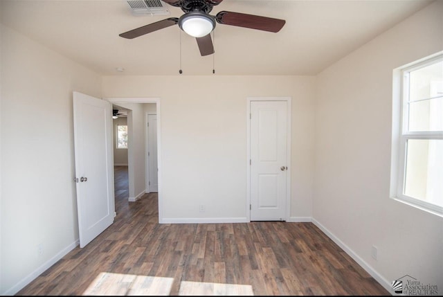 350 S Monte Vis, Yuma, AZ 85364 - unfurnished bedroom featuring visible vents, baseboards, ceiling fan, and wood finished floors