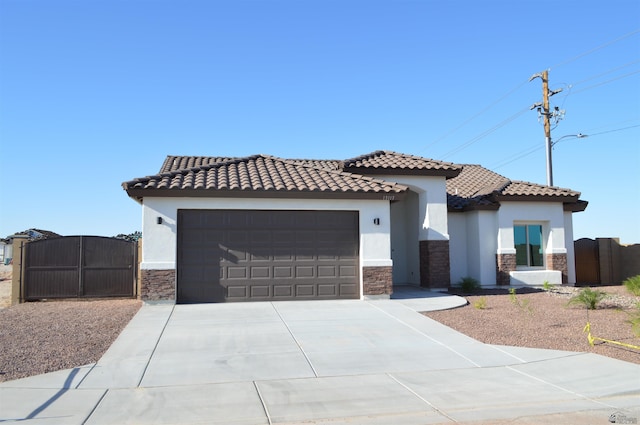 13113 E 54th St Lot 37, Yuma, AZ 85367 - mediterranean / spanish-style house featuring stone siding, a gate, and stucco siding