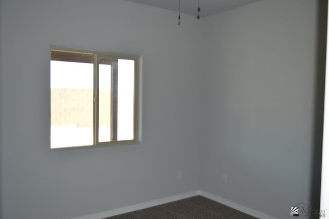 13113 E 54th St Lot 37, Yuma, AZ 85367 - unfurnished room with baseboards and dark carpet