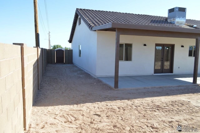 13113 E 54th St Lot 37, Yuma, AZ 85367 - rear view of property with french doors, a tiled roof, a patio, and stucco siding