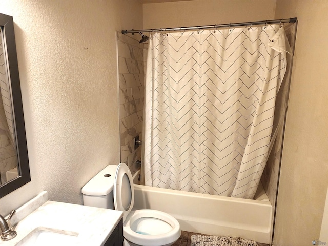 full bathroom with vanity, a textured wall, toilet, and shower / bath combination with curtain