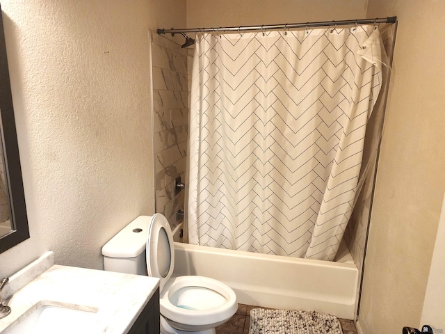 bathroom with a textured wall, tile patterned flooring, vanity, shower / tub combo with curtain, and toilet