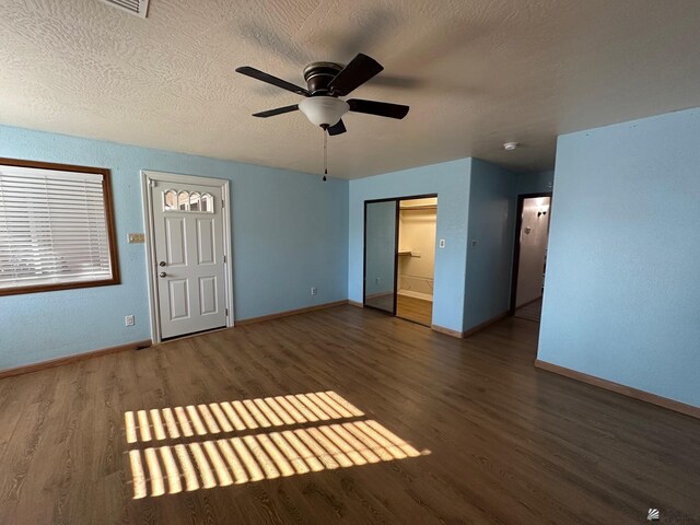 1319 W 18th Pl, Yuma, AZ 85364 - unfurnished bedroom featuring wood finished floors, baseboards, a textured ceiling, and a ceiling fan