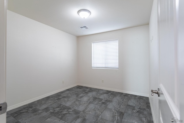 3830 E Jett St, San Luis, AZ 85336 - spare room featuring dark marble finish flooring and baseboards