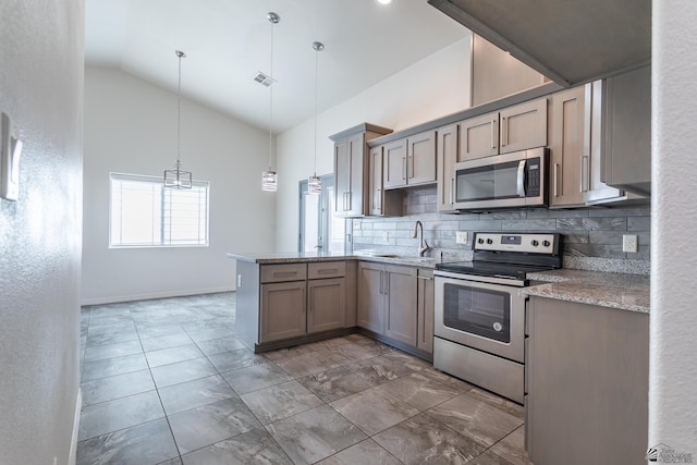 3830 E Jett St, San Luis, AZ 85336 - kitchen with stainless steel appliances, a sink, tasteful backsplash, a peninsula, and pendant lighting