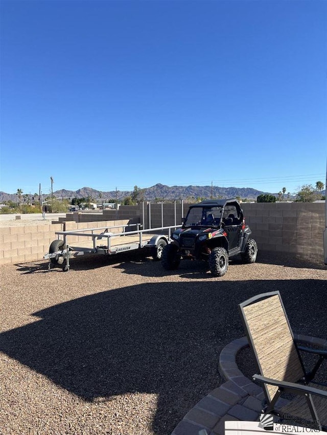 view of vehicle parking featuring a mountain view