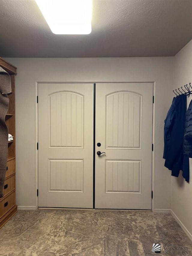 interior space with a textured ceiling and a closet