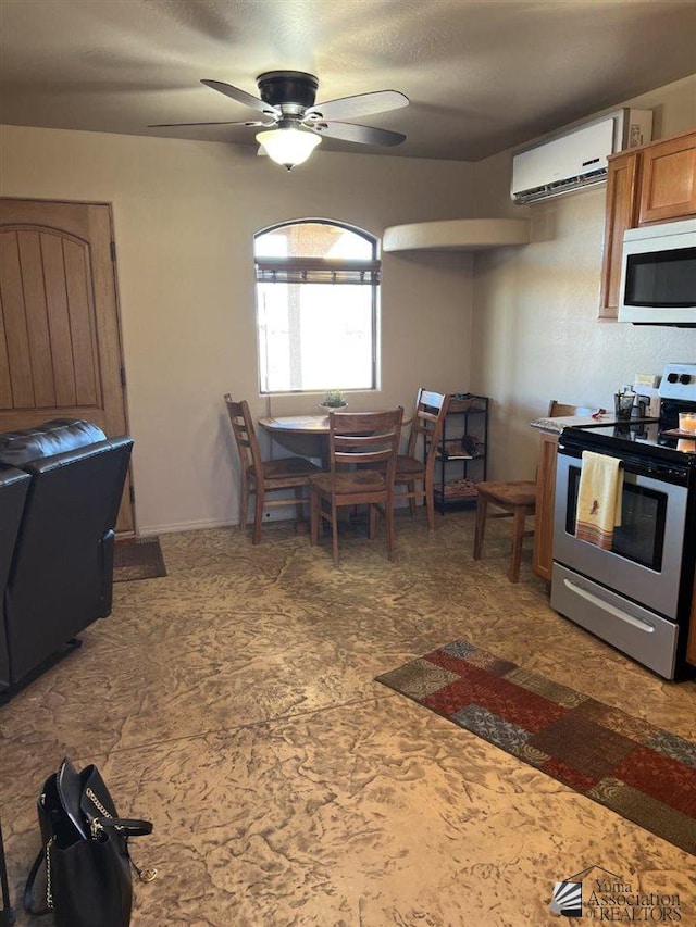 kitchen with a wall mounted air conditioner, ceiling fan, and stainless steel range with electric cooktop