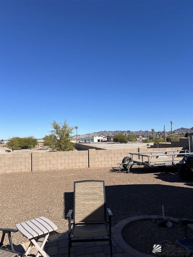 view of yard with a mountain view and a patio