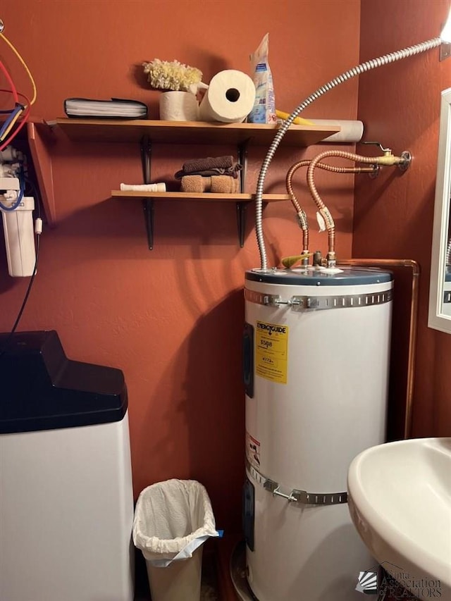 utility room with secured water heater and sink