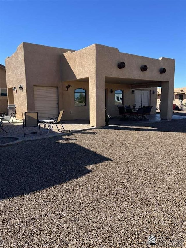 rear view of property featuring a patio area