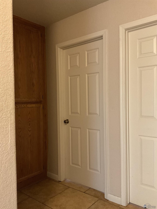hallway featuring light tile patterned floors