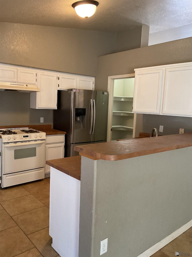 kitchen with white cabinets, stainless steel fridge with ice dispenser, tile patterned floors, white range with gas stovetop, and under cabinet range hood