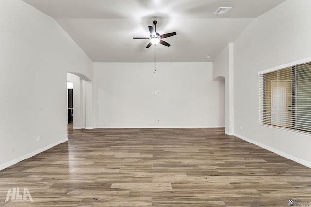 12616 E 49th Dr, Yuma, AZ 85367 - unfurnished living room with arched walkways, a ceiling fan, wood finished floors, lofted ceiling, and visible vents