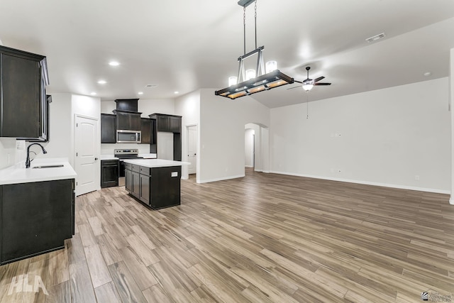 12616 E 49th Dr, Yuma, AZ 85367 - kitchen with a ceiling fan, visible vents, arched walkways, a sink, and stainless steel appliances