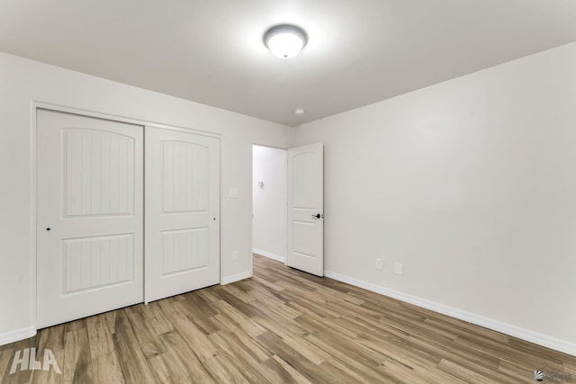 12616 E 49th Dr, Yuma, AZ 85367 - unfurnished bedroom featuring baseboards, a closet, and wood finished floors