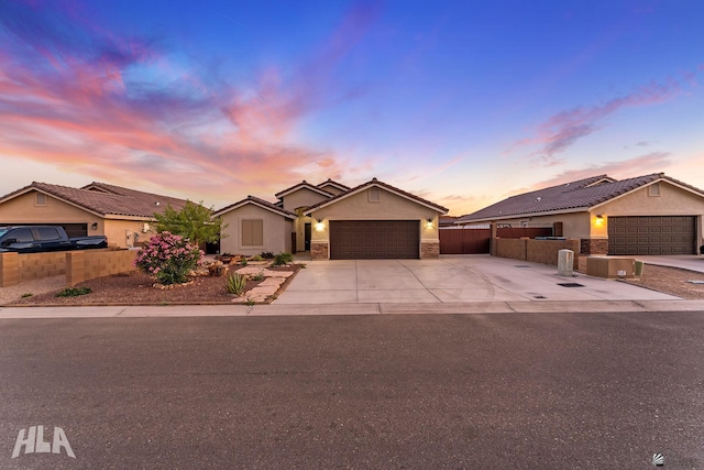 12616 E 49th Dr, Yuma, AZ 85367 - ranch-style home with a garage, fence, stone siding, stucco siding, and concrete driveway