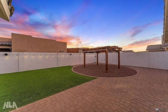 12616 E 49th Dr, Yuma, AZ 85367 - yard at dusk with a pergola, a fenced backyard, and a patio area