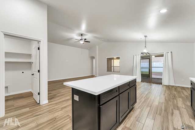 12616 E 49th Dr, Yuma, AZ 85367 - kitchen with light wood-type flooring, a ceiling fan, lofted ceiling, and light countertops