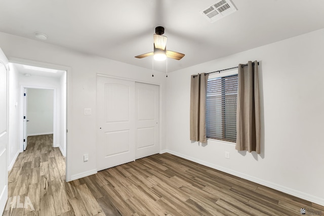 12616 E 49th Dr, Yuma, AZ 85367 - unfurnished bedroom with ceiling fan, visible vents, wood finished floors, baseboards, and a closet