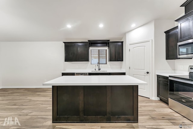 12616 E 49th Dr, Yuma, AZ 85367 - kitchen with a sink, light countertops, stainless steel appliances, and light wood-type flooring