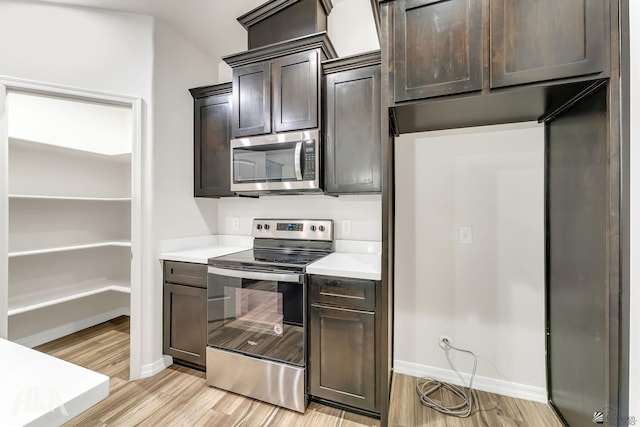 12616 E 49th Dr, Yuma, AZ 85367 - kitchen featuring dark brown cabinets, baseboards, light wood-type flooring, light countertops, and appliances with stainless steel finishes